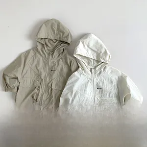 Detail of kids hooded sun protection jackets with double pockets and Plant text