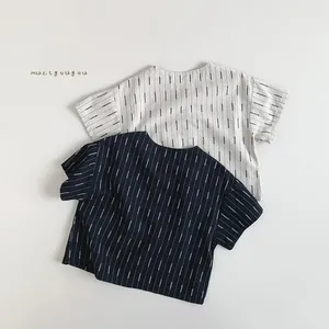 Flat lay of striped short-sleeve kids' cotton shirts in cream and navy blue styles