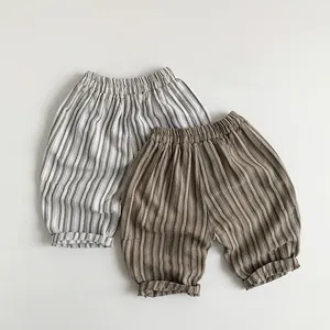 Detail of kids striped cotton linen pants in grey and brown with elastic waist