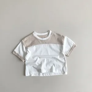 Detailed view of kids' cotton T-shirt featuring contrast collar and neutral stitching details