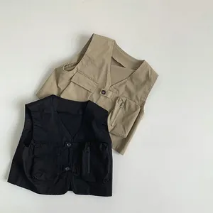 Flat lay of khaki and black kids cargo vests with functional multi-pockets and V-neck line