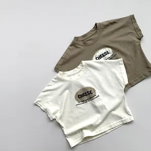 Close-up of kids cotton t-shirts in beige and olive green with cheese print design