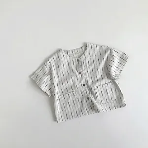 Detail of children striped cotton shirt with round collar and two front square pockets