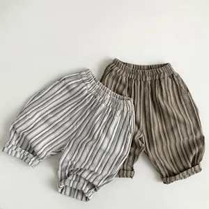 Detailed view of elastic waist and vertical stripe texture on cotton linen kids pants