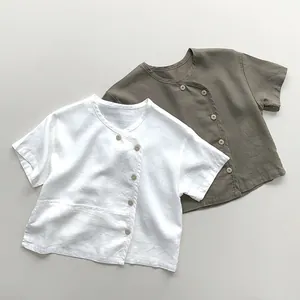 Detail view of linen blend kids shirts with unique side button closure in white and olive