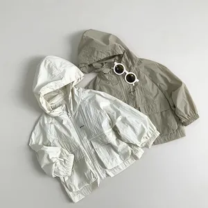 Flat lay detail of kids hooded windbreaker jackets with zip closure and elastic cuffs