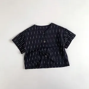 Macro detail of navy blue striped cotton shirt with round neck and buttons for kids