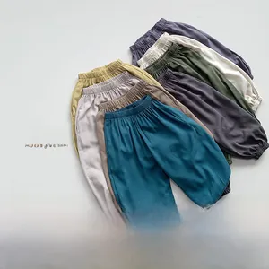 Detailed close-up of lightweight pleated fabric and elastic waist on kids mosquito pants