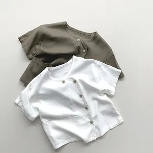 Detail of linen cotton kids shirts with side buttons and natural wood fasteners