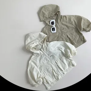 Detail of lightweight kids sun protection jackets with hoodies and functional pockets