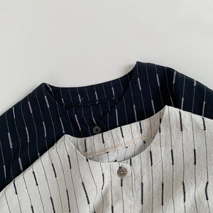 Detailed macro view of vintage buttons and striped texture on kids cotton shirts