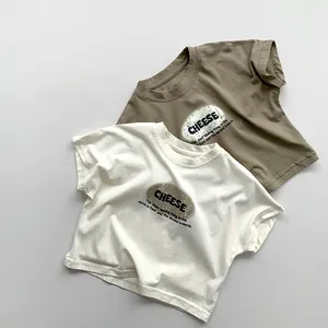 Flat lay of cream and olive green cotton t-shirts with CHEESE print and raglan sleeves