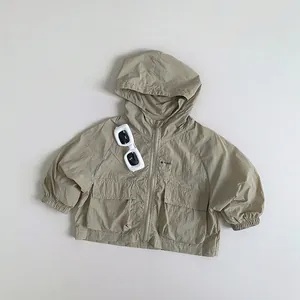 Detail of light khaki hooded sun protection jacket with zip closure and large cargo pockets