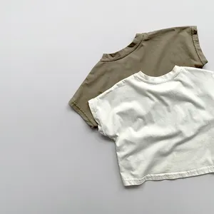 Close-up of minimalist cotton t-shirts in charcoal and beige with soft fabric texture