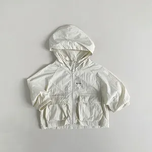 Detailed close-up of kids' lightweight hooded sun protection jacket in beige