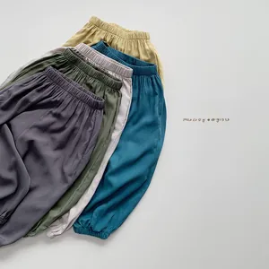 Detailed stack of kids lightweight mosquito pants in multiple natural earth tone colors