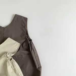 Detail view of cotton linen kids' overalls with elastic cuffs and side pocket texture