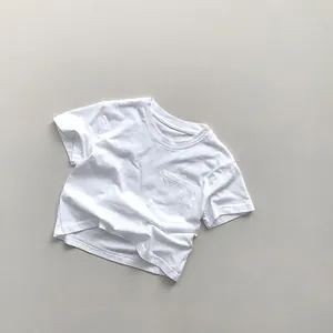 Macro shot of cotton fabric texture and front pocket detail on white short sleeve kids T-shirt