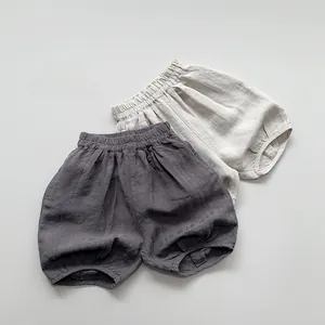 Vue détaillée à plat de bloomers enfant en coton et lin respirant gris et beige