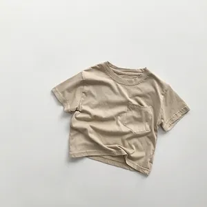 Close-up of kids' cotton t-shirt with round neck and square chest pocket detail