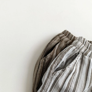 Detail of kids striped cotton linen pants showing elastic waistband and side pocket