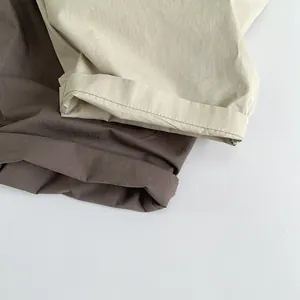 Close-up of lightweight cotton linen overalls showing hem detail and fabric texture