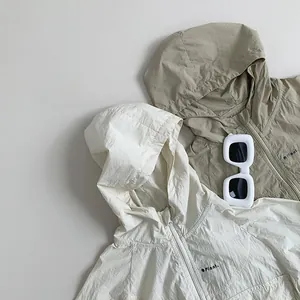 Flat lay of lightweight hooded sun protection jackets in off-white and khaki green colors