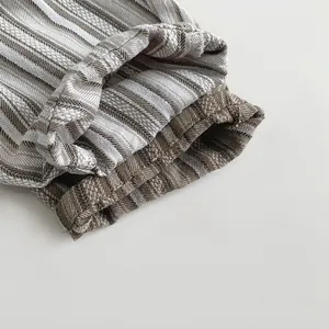 Macro detail of natural striped cotton fabric texture and stitching on kids' capri pants