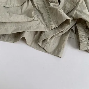 Kids lightweight sunscreen jacket in beige with utility pockets and windproof fabric