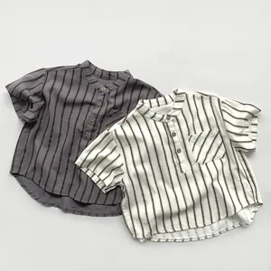 Detail of baby striped short sleeve shirts in dark grey and beige cotton linen fabric