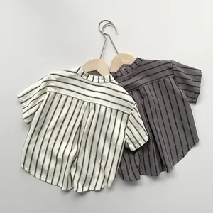Close-up of beige and dark grey vertical striped cotton linen kids shirts with mandarin collars