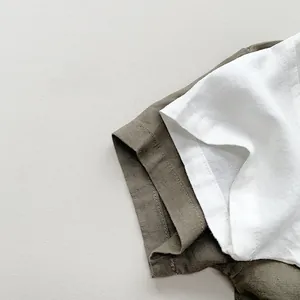 Detail shot of breathable white and olive green linen fabric texture for kids shirts