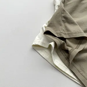 Detail of reinforced double-needle stitching on the hem of cotton children's t-shirts