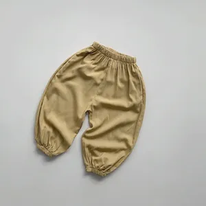 Detail of kids elastic waist mosquito pants in ginger yellow with ribbed ankle cuffs