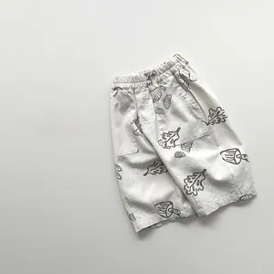 Detail showing natural linen texture and hand-drawn nature prints on toddler summer shorts