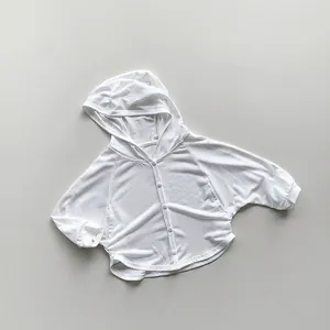 Macro detail of breathable white knit fabric on children's hooded sun protection cardigan