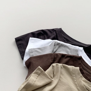 Detail view of cotton t-shirt necklines and shoulders in multiple neutral colors