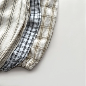 Detail showing elastic cuffs and checkered cotton fabric textures for kids summer pants