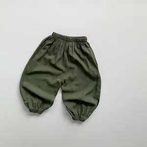 Detailed view of elastic waistband and cuffed ankles on green children mosquito pants