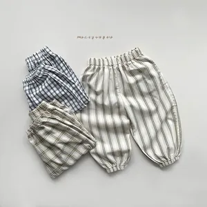 Detail of plaid and striped cotton anti-mosquito pants with elastic waist and cuffs