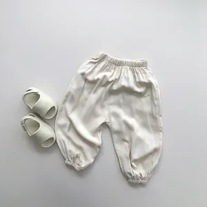 Detail view of cream children's mosquito pants with elastic waist and soft cotton texture
