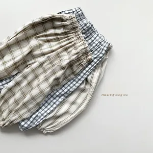 Detailed view of elastic waistbands and textures on kids plaid and striped cotton pants