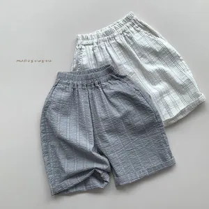 Close-up of breathable seersucker striped kids' pants with elastic waist and rolled cuffs