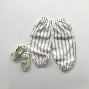 Detail of kids striped harem pants with elastic waistband and ankle cuffs in cream
