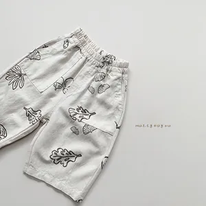 Close-up of kids linen cotton shorts featuring acorn prints and elastic waist detail