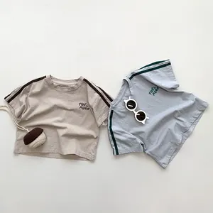 Flat lay of Korean style kids cotton T-shirts with striped sleeves and Moon embroidery