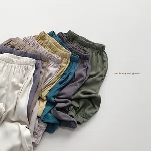 Close-up of silky loose kids mosquito pants showing elastic waistband and diverse colors