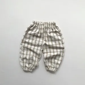 Detail of breathable plaid kids' mosquito pants with elastic waistband and cuffed ankles