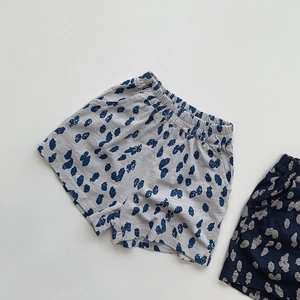 Detail view of kids cotton polka dot shorts with elastic waist and side pockets