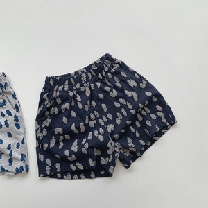 Detailed flat lay of navy blue kids' cotton shorts with polka dot print and elastic waist